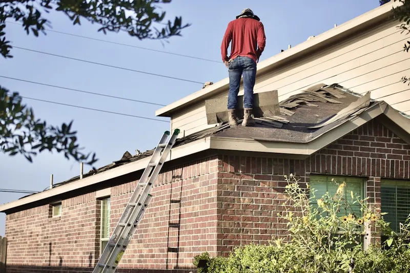 Professional roofer working on a residential roof in North Hollow